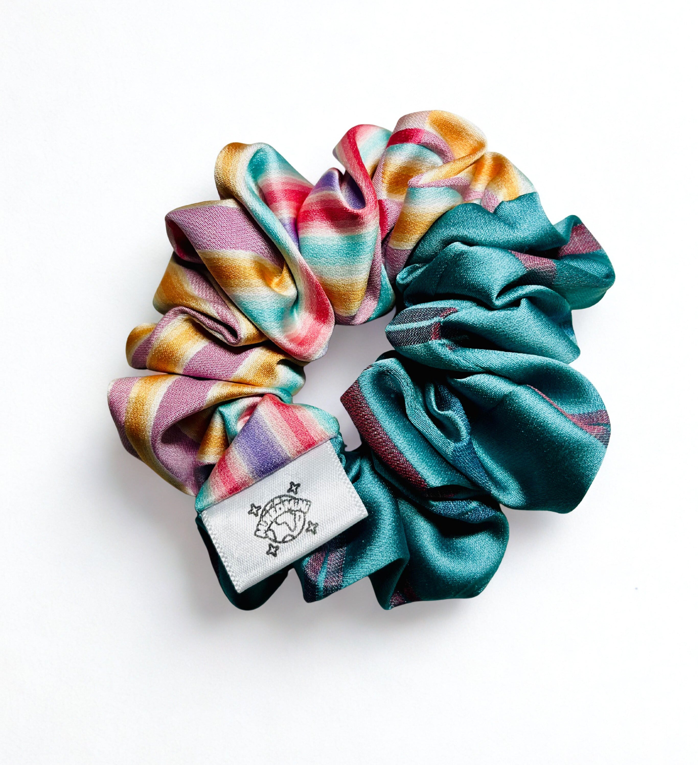 Scrunchie made from upcycled kimono fabric in mixed bright colors with a small logo tag