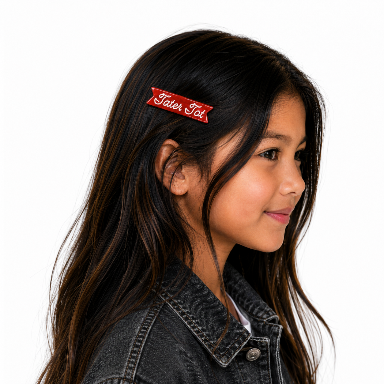 Girl with a red hair clip labeled 'Tater Tot' on a white background